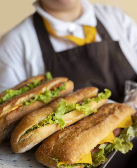 close-up-young-chef-holding-sandwiches close-up-young-chef-holding-sandwiches